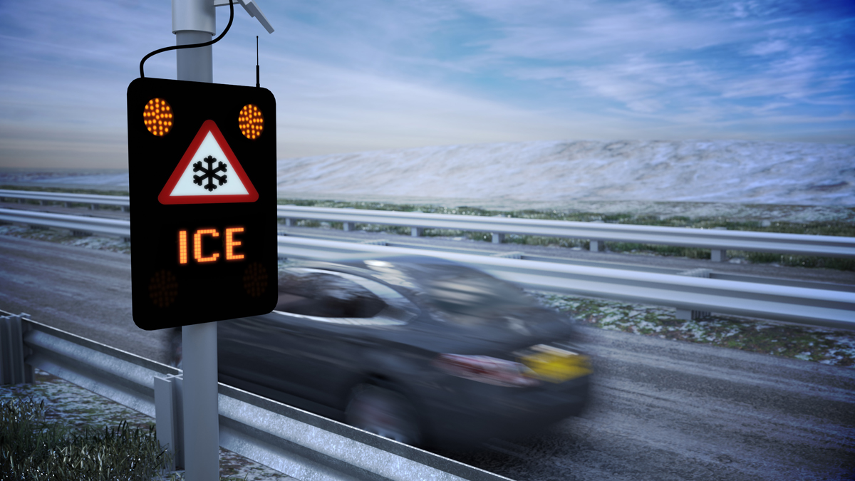 Realistic 3D Animation of a car driving very fast past an electronic ice warning sign on a motorway