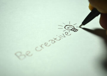 Be creative with a lightbulb doodle being written on some pale green paper