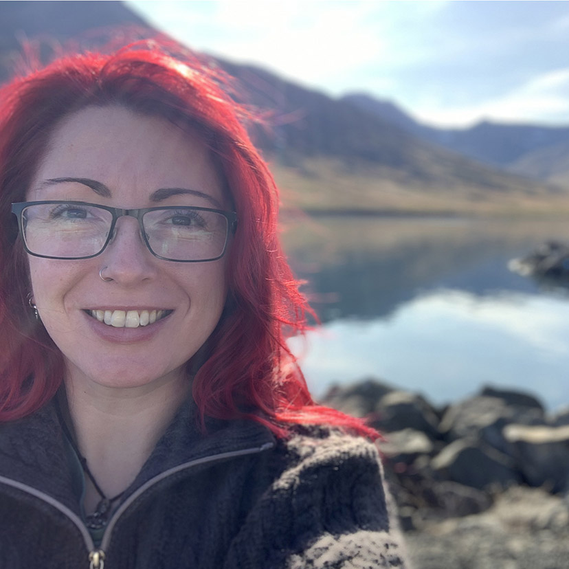 A photograph of our Lead Animator in front of a lake in the mountains